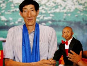 Nice to meet you... the world's tallest man, Bao Xishun (left), shakes hands with He Pingping, who only measures 72 centimetres.